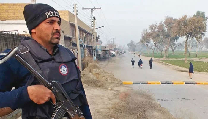 A policeman stands guard near the site of an attack in Bannu. — AFP/File