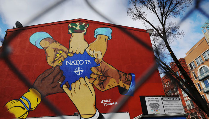 An artwork celebrating the 75th anniversary of NATO in 2024 is painted on the wall behind a chain link fence in Washington, DC, US, March 6, 2025. — Reuters