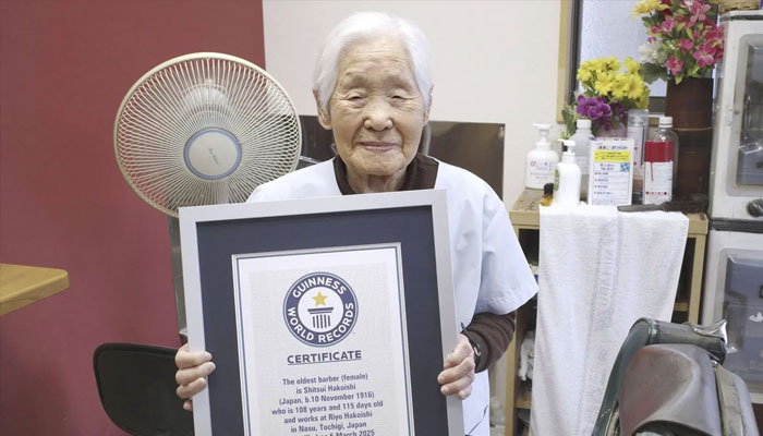 Shitsui Hakoishi, 108, poses for a photo with a Guinness World Records certificate recognizing her as the worlds oldest female barber, at her shop in Nakagawa in Tochigi Prefecture, eastern Japan, on Wednesday March 5, 2025.— AFP