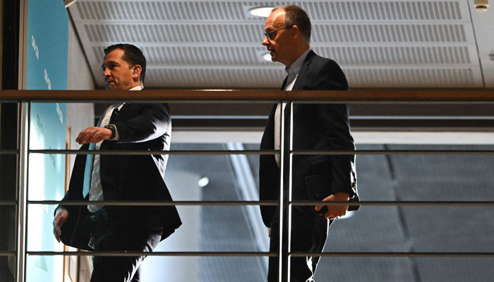 The leader of Germany´s Christian Democratic Union (CDU) party Friedrich Merz (R) is seen at a parliamentary building in Berlin on March 7, 2025. — AFP