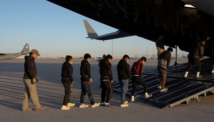 Migrants board a C-17 Globemaster III aircraft for a removal flight, Fort Bliss, Texas, US on January 23, 2025. — Reuters