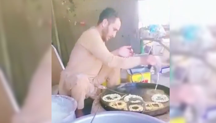 Football player Muhammad Riaz can be seen making Jalebis. — Screengrab via YouTube/Maqsood Chitral
