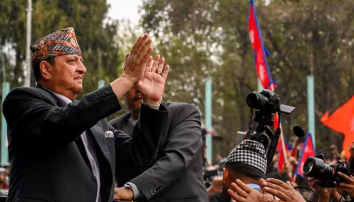 Nepals former King Gyanendra Bir Bikram Shah Dev waves as he arrives at Tribhuwan International Airport in Kathmandu on Mar 9, 2025. —AFP