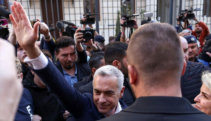 Calin Georgescu greets supporters gathered in front of the Romanian electoral commission in Bucharest on March 7, 2025.—Reuters