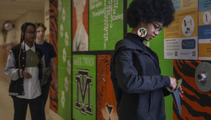 An students at Twain Middle School in Virginia storing her phone in magnetic pouche at the start of day. —AFP/File