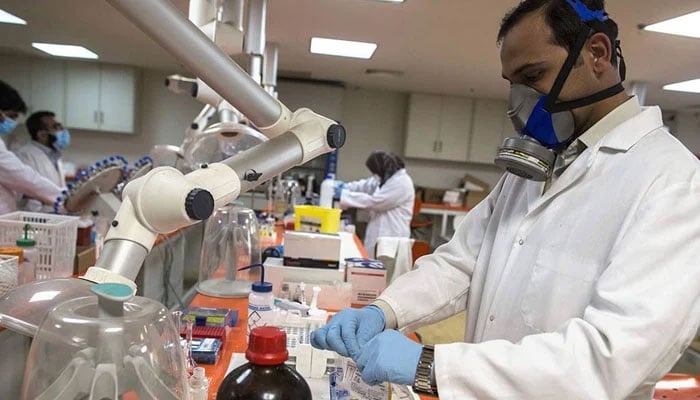 A representational image of  multiple researchers handling various equipment in a lab. — Reuters/File