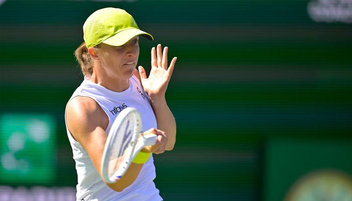 Iga Swiatek hits a shot in the third round of the BNP Paribas Open at the Indian Well Tennis Garden.—Reuters