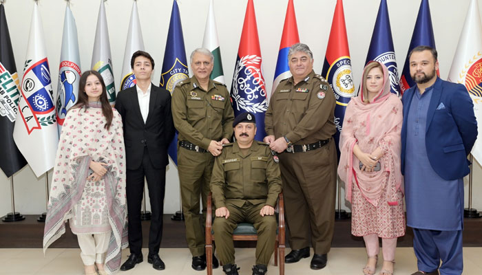 IG Punjab Dr Usman Anwar (centre left) and senior officer pin promotion rank on a promoted officer on March 10, 2025. — Facebook@PunjabPolicePakistanOfficial