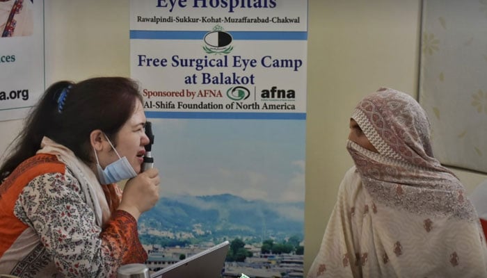 A female doctor examines the eyes of a patient on June 31, 2024. — Facebook@Al-Shifa Trust Eye Hospital