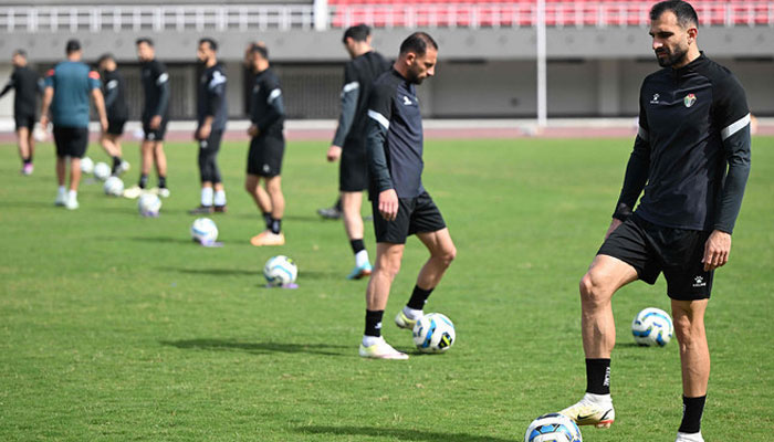Football players warm up during a training session at the Jinnah Sports Stadium in Islamabad on March 20, 2024. — AFP