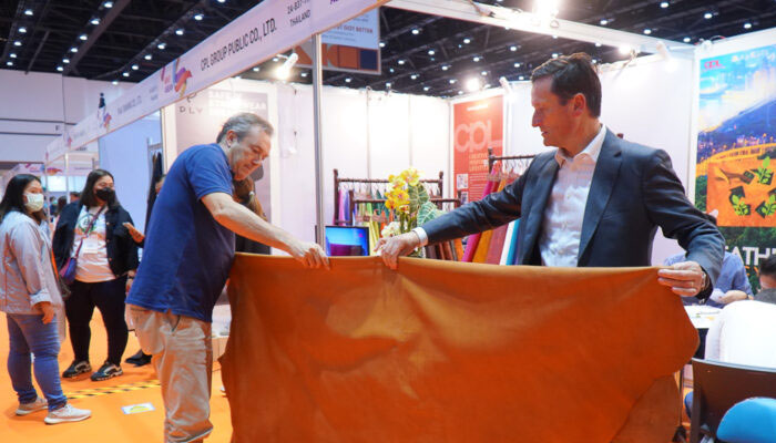 Two persons inspecting leather at Hong Kong’s leather trade fair. —aplf website/File