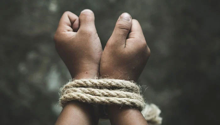The representational image shows a child with both hands tied together. — APP/File