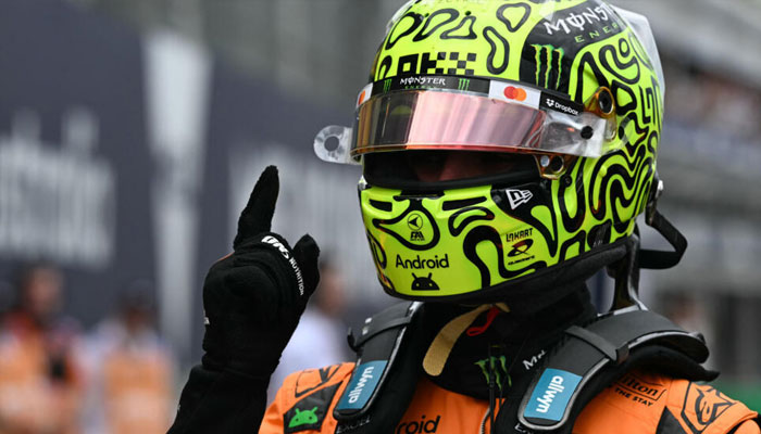 Lando Norris gives a number one sign after taking pole position in Melbourne. —AFP/File