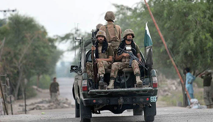 Armed security forces personnel ride an army van. — AFP/File