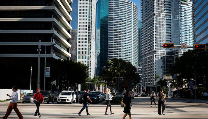 People cross the intersection of SW 8th Steet and Brickell Ave at the Brickell neighborhood, known as the financial district, in Miami, Florida, US, February 23, 2023.—Reuters