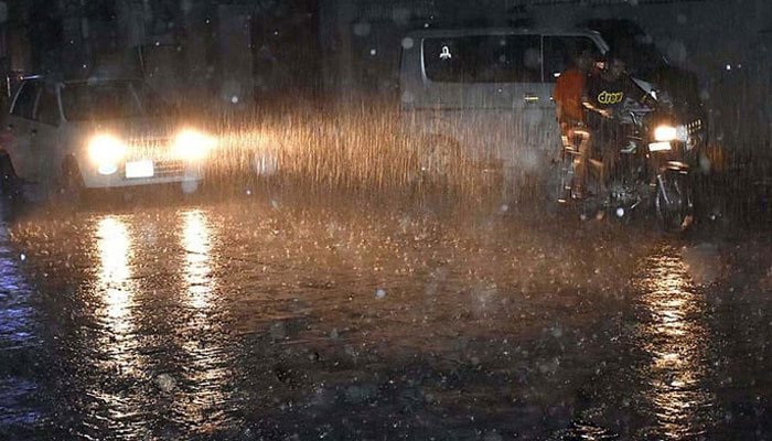 People commuting during heavy rain, on June 25, 2023. — APP
