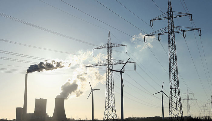 A factory can be seen alongside heavy transmission lines. — AFP/File