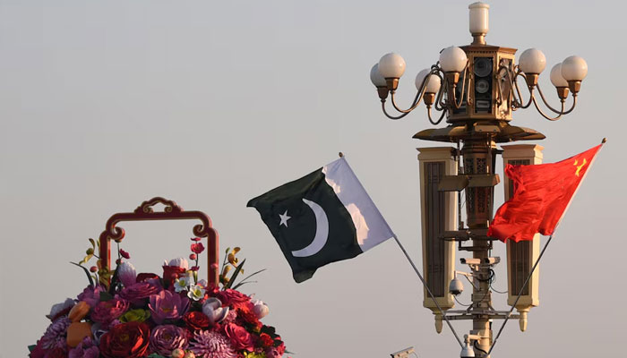 Pakistani and Chinese national flags flutter next to an installation featuring a giant flower basket at the Tiananmen Square in Beijing, China October 7, 2019.—Reuters