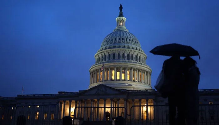 A couple stands outside the US Capitol Building in Washington, DC. — AFP/File