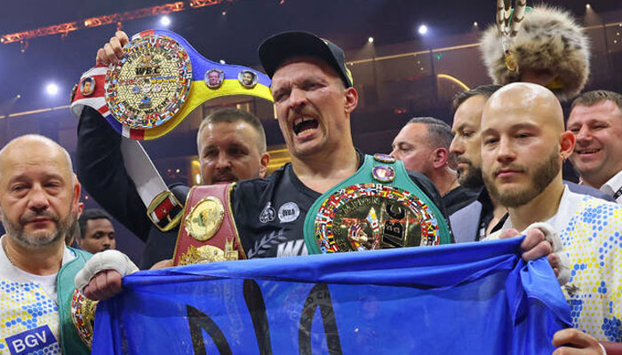 Ukraines Oleksandr Usyk (centre) celebrates his victory over Britains Tyson Fury during a heavyweight boxing world championship fight at Kingdom Arena in Riyadh on May 19, 2024. — AFP