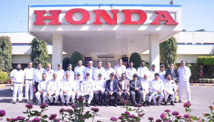 Honda officials posing for a photgraph. —APP/File