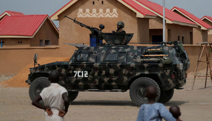An armored vehicle of Nigerian Security Forces drives by newly built homes, ahead of the community re-opening ceremony which was destroyed by Boko Haram armed militants in 2015, in Ngarannam, Borno State, Nigeria, October 21, 2022. —Reuters
