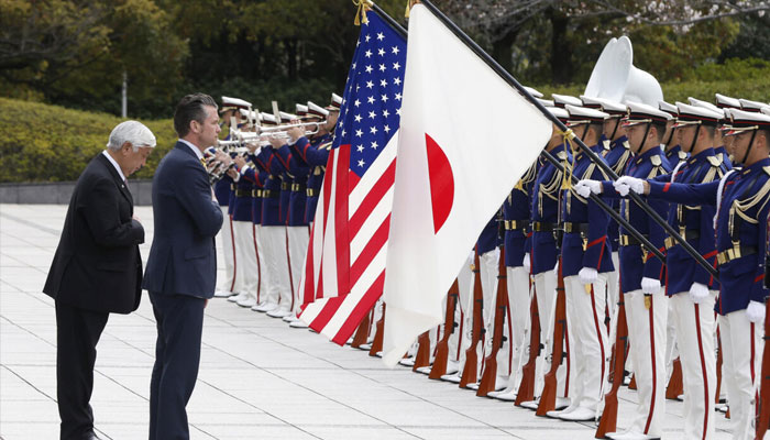 Japans Defence Minister Gen Nakatani and US Secretary of Defense Pete Hegseth review an honor guard at the Ministry of Defence in Tokyo. —AFP/File