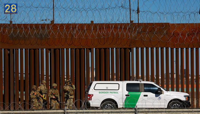 Members of the Texas National Guard stand guard near the border wall between Mexico and the United States, as seen from Ciudad Juarez, Mexico, January 14, 2025. — Reuters