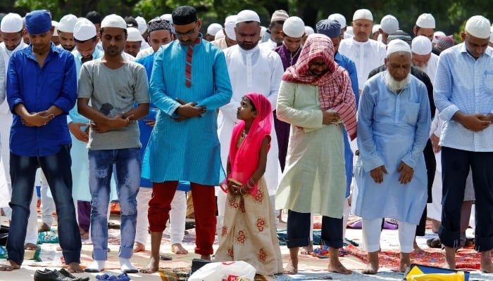 People offer Eid ul Fitr prayers marking the end of the holy fasting month Ramadan on a road in Kolkata, June 16, 2018. — Reuters