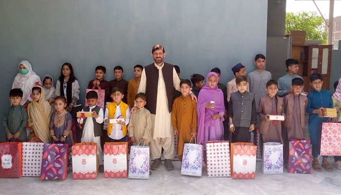 Children pose for a group during a gift distribution ceremony arranged by the Alkhidmat Foundation on March 2, 2025. — Facebook@Alkhidmatfoundationkp