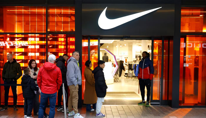 General view as people queue up outside a Nike shop close to the stadium before the match. —Reuters/File