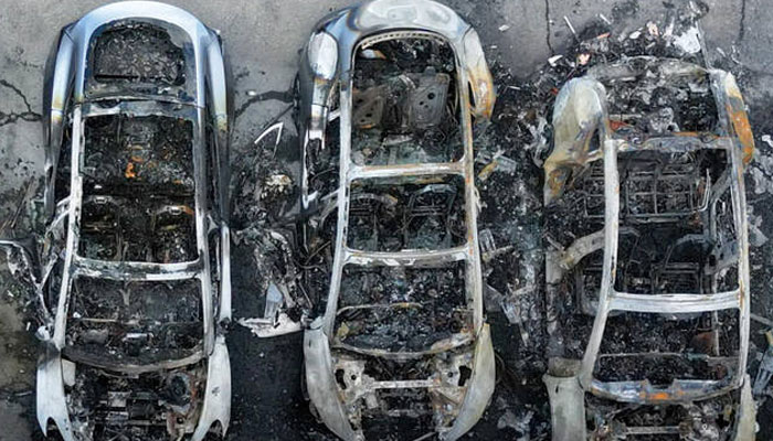 A drone view shows charred Tesla vehicles following a fire at a Tesla dealership that destroyed vehicles, in Rome, Italy, Mar. 31, 2025. —Reuters