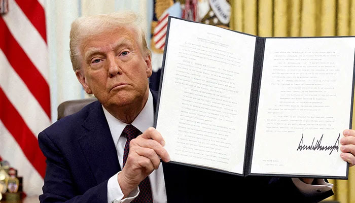 US President Donald Trump holds a signed executive order on cryptocurrencies, in the Oval Office of the White House, in Washington, US, January 23, 2025.— Reuters