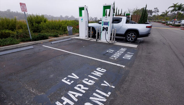 Electric vehicle chargers from Electrify America are shown in a shopping center parking lot in Oceanside, California, US, October 19, 2023. —Reuters