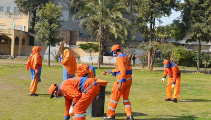 Rawalpindi Waste Management Company workers perform their duties. — Facebook@Rawalpindi Waste Management Company/File