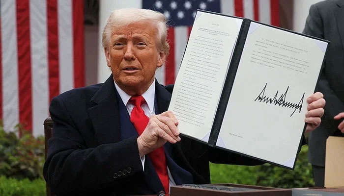US President Donald Trump holds a signed executive order on tariffs, in the Rose Garden at the White House in Washington, DC, US, April 2, 2025. — Reuters