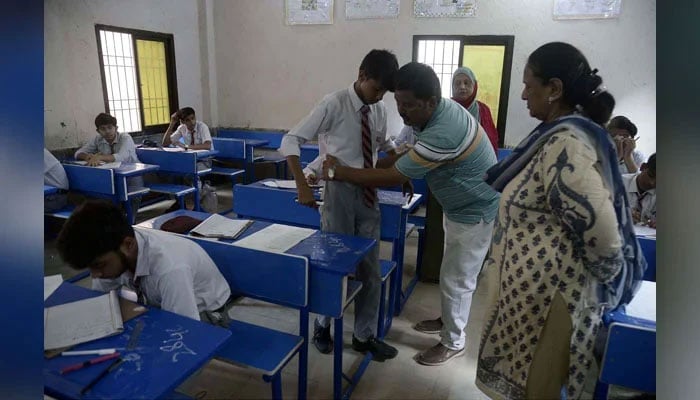 Students of matric class solving paper in examination center on May 13, 2024. — PPI