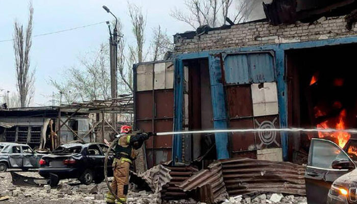 A firefiughter seen in fron of a building on fire. — AFP/File