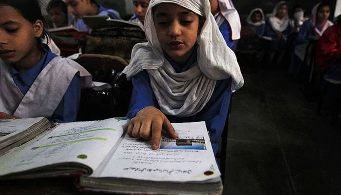 In this image a student is reading a book in a classroom. — Reuters/File