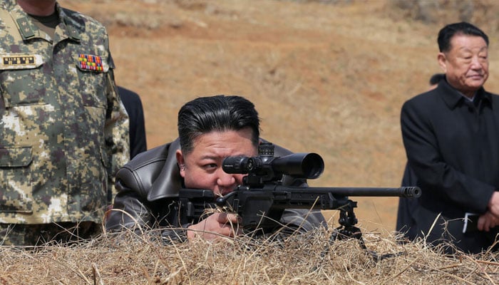 Images released by state media showed Kim peering through the scope of a sniper rifle on a visit to special forces. —AFP/File