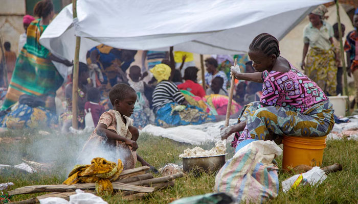 A Congolese woman prepares a meal near a temporary shelter at Rugombo Stadium, after fleeing from renewed clashes between M23 rebels and the Armed Forces of the Democratic Republic of the Congo (FARDC), in Rugombo commune of Cibitoke Province, Burundi February 18, 2025. —Reuters