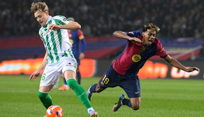 Real Betis Spanish forward Jesus Rodriguez (left) controls the ball past Barcelonas Spanish forward Lamine Yamal during the Spanish league football match between FC Barcelona and Real Betis at the Estadi Olimpic Lluis Companys in Barcelona, on April 5, 2025.— AFP