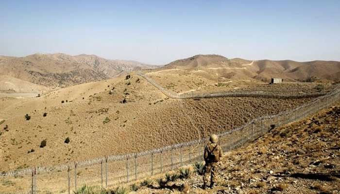 A soldier stands guard along the border fence outside the Kitton outpost on the border with Afghanistan in North Waziristan, Pakistan October 18, 2017. — Reuters