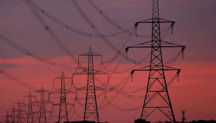 Sun rises behind electricity pylons near Chester, northern England October 24, 2011. — Reuters