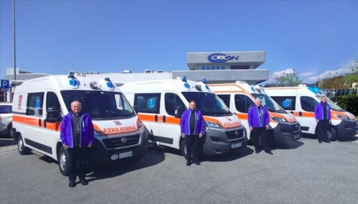 Drivers standing infront of the delivered ambulances. —Holy See/File
