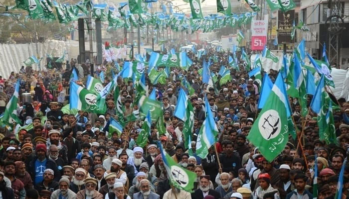 Supporters of the Jamaat-e-Islami protest holding flags at a rally. — Online/File