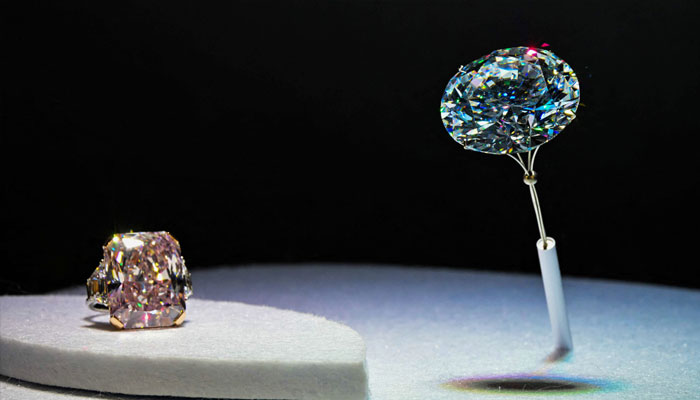 The 102.60-carat round white diamond (right) is displayed alongside the 40.29-carat radiant-cut fancy light pink diamond ring during a preview before a public exhibition in Abu Dhabi on April 8, 2025. —AFP