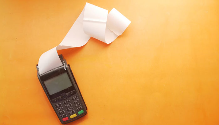 This representational shows a financial receipt coming out from a machine. — Unsplash/File
