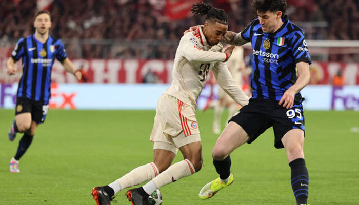 Bayern Munichs French midfielder #17 Michael Olise and Inter Milans Italian defender #95 Alessandro Bastoni (right) vie for the ball during the UEFA Champions League first leg quarter-final football match between FC Bayern Munich and Inter Milan in Munich, southern Germany, on April 8, 2025. — AFP