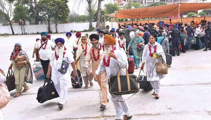 Sikh Yatrees arrive at Wagah Border to participate in the religious rituals in Pakistan on April 13, 2024. — APP